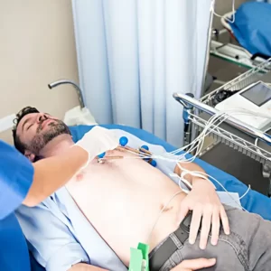 man with sensors attached undergoing an EKG to test his heart and blood flow