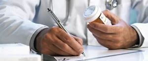 doctor writing a prescription as the header for The Prescription, a blog page