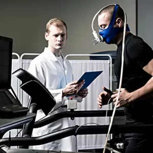 a masked man on a treadmill performing a stress test as a technician looks on