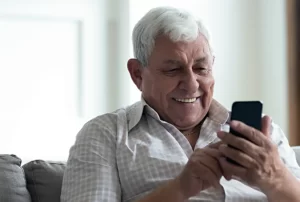 senior man making a doctor's appointment using a cell phone