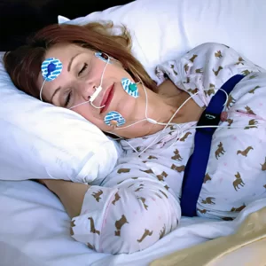 sleeping woman in bed with sensors attached for her sleep study